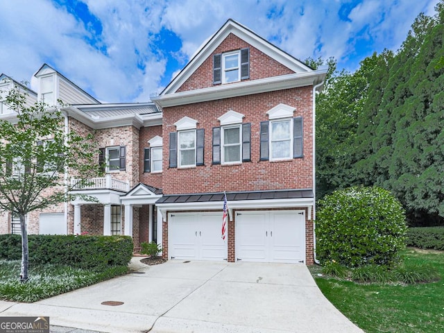 5605 Waters Edge Trl, Roswell, GA 30075 - view of front of house featuring driveway, a garage, brick siding, a standing seam roof, and metal roof