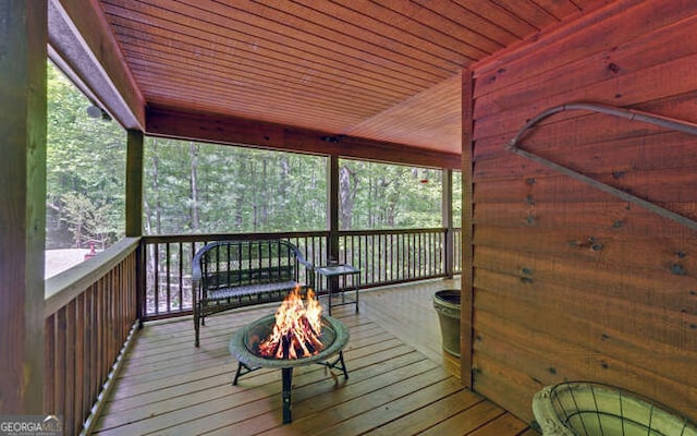 wooden terrace with an outdoor fire pit