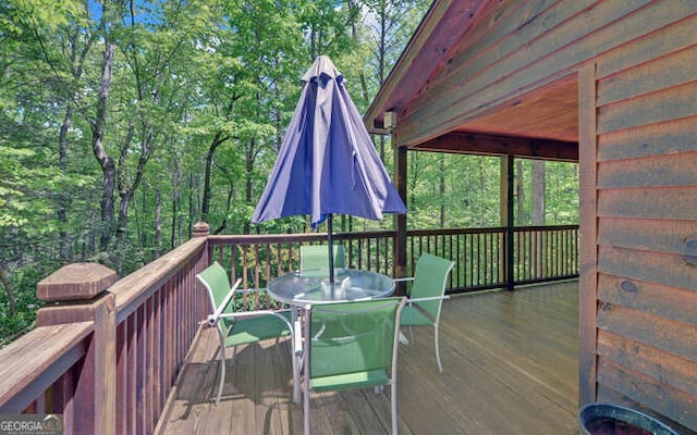 deck with outdoor dining area