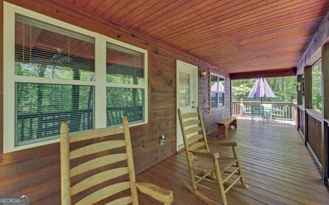 wooden terrace featuring covered porch