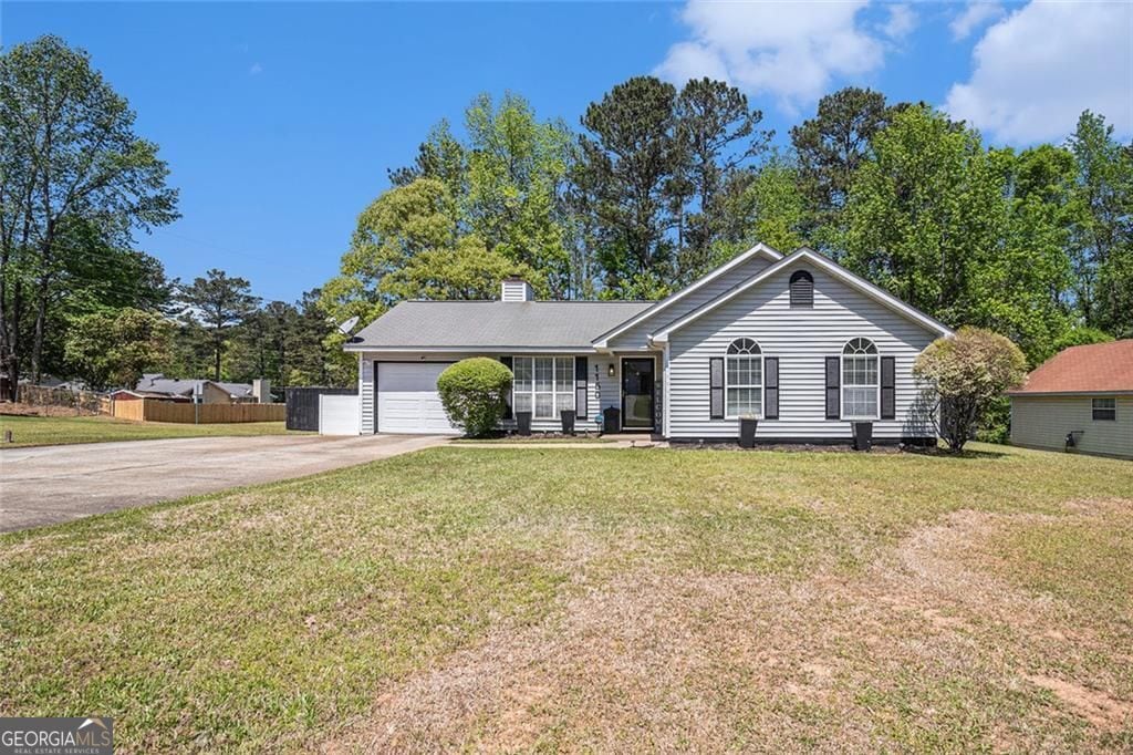 1150 Bonita Cir, Jonesboro, GA 30238 - ranch-style house featuring driveway, a garage, and a chimney