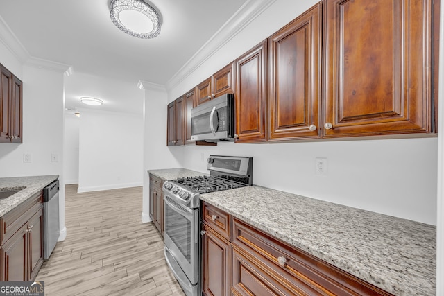 kitchen with stainless steel appliances, light stone counters, light wood-style floors, crown molding, and baseboards