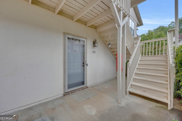 doorway to property featuring stucco siding and a patio