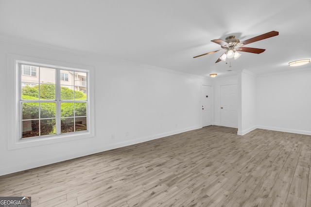 unfurnished room with wood finished floors, ceiling fan, ornamental molding, and baseboards
