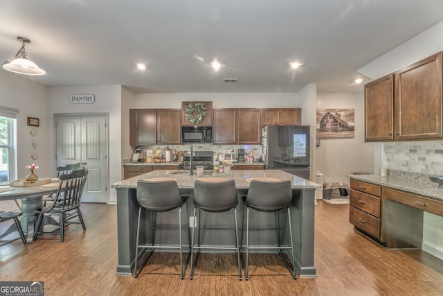 214 Willowbrook Way SE, Calhoun, GA 30701 - kitchen featuring stainless steel appliances, tasteful backsplash, dark wood-style flooring, a breakfast bar, and recessed lighting
