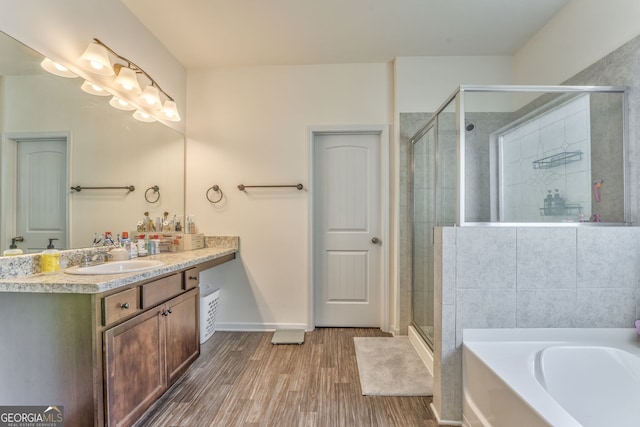 214 Willowbrook Way SE, Calhoun, GA 30701 - bathroom featuring vanity, wood finished floors, a bath, a shower stall, and baseboards