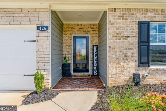 426 Samara Ct, Fairburn, GA 30213 - doorway to property featuring a garage and brick siding