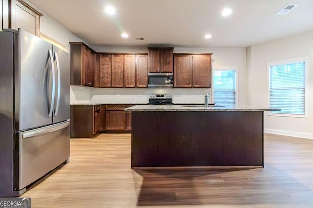 255 Dublin Way, Dallas, GA 30132 - kitchen with appliances with stainless steel finishes, a sink, light wood-style flooring, light stone counters, and recessed lighting
