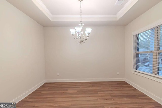 255 Dublin Way, Dallas, GA 30132 - spare room with a tray ceiling, wood finished floors, a chandelier, and crown molding