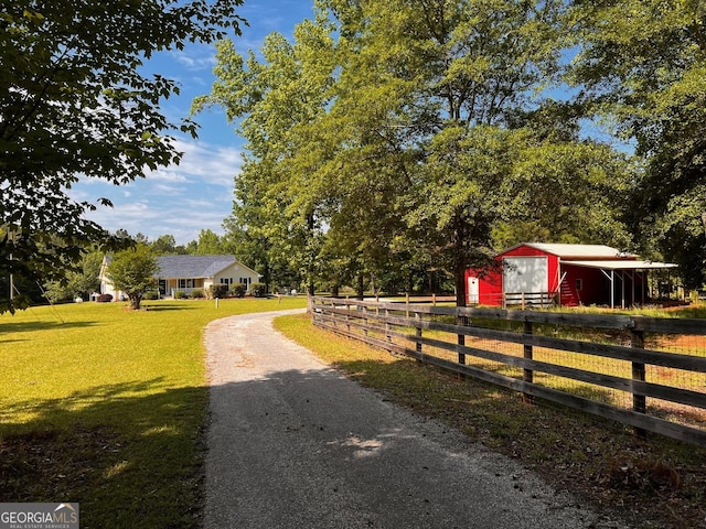 view of asphalt driveway featuring a pole building