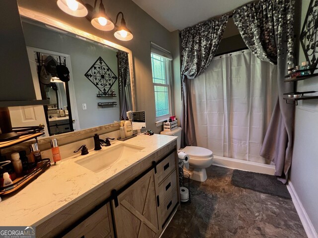 bathroom featuring a stall shower, toilet, and vanity