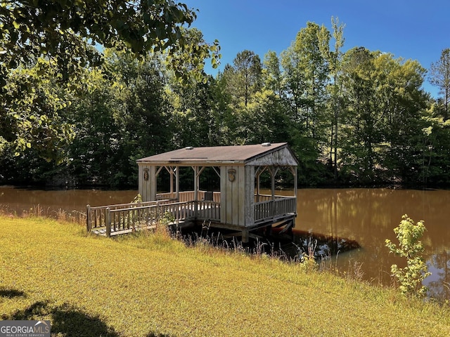 view of yard featuring a gazebo, a water view, and a wooded view