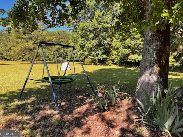view of grassy yard with a playground