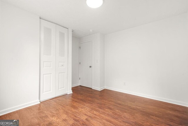 1355 Tucker Woods Dr, Norcross, GA 30093 - unfurnished bedroom featuring wood finished floors, baseboards, and a closet
