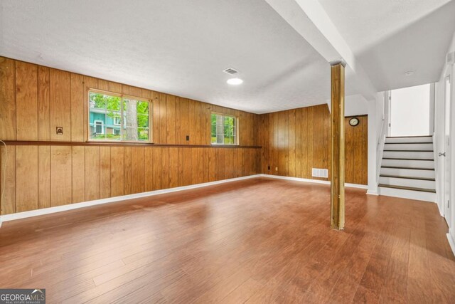 1355 Tucker Woods Dr, Norcross, GA 30093 - below grade area with wood finished floors, stairs, wood walls, and baseboards