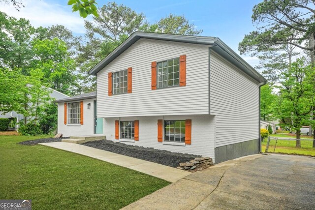 1355 Tucker Woods Dr, Norcross, GA 30093 - split level home with brick siding and driveway