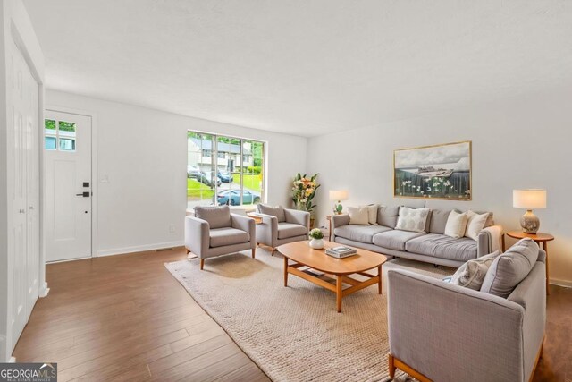 1355 Tucker Woods Dr, Norcross, GA 30093 - living area with plenty of natural light, wood finished floors, and baseboards