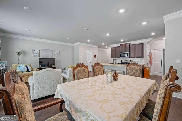 dining room with crown molding, recessed lighting, and dark wood-style floors