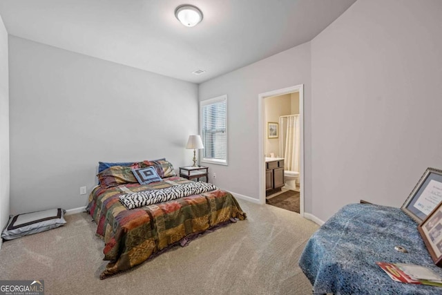 bedroom with carpet floors, baseboards, and ensuite bathroom