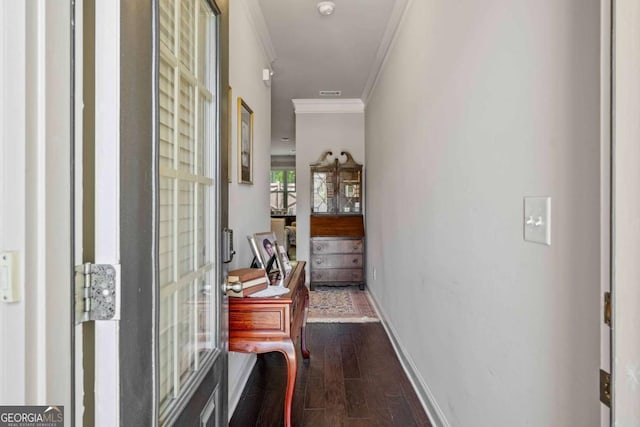 hallway with crown molding, dark wood-type flooring, and baseboards
