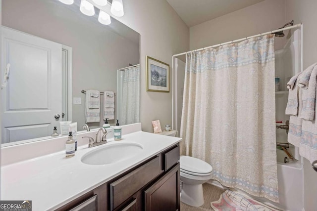 full bathroom featuring toilet, vanity, and shower / bath combo with shower curtain