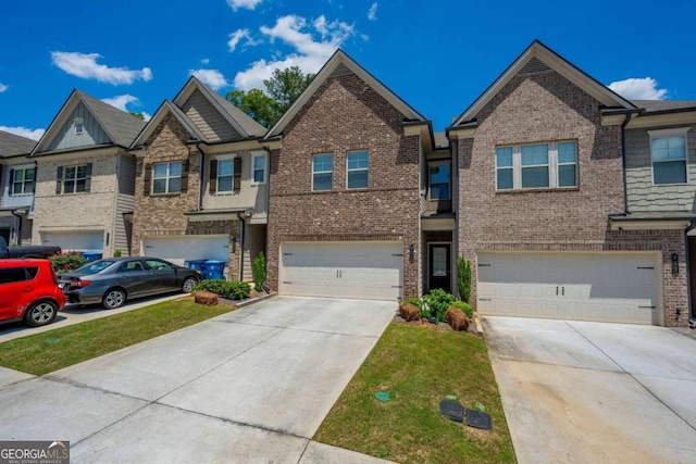 multi unit property with a garage, driveway, and brick siding