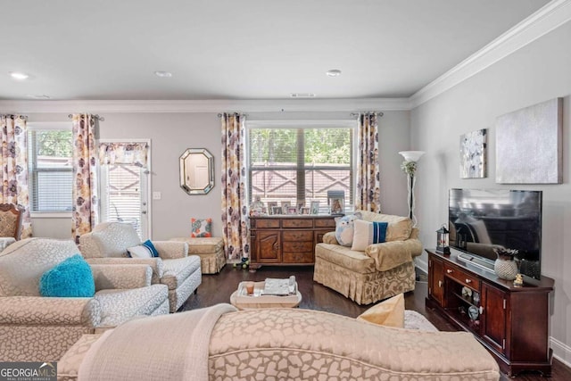living room with dark wood finished floors, crown molding, and healthy amount of natural light