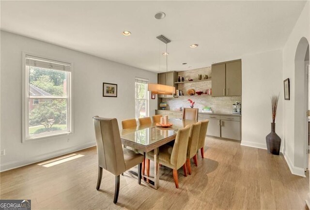 1420 Cortez Ln NE, Atlanta, GA 30319 - dining room with light wood-style floors, arched walkways, and recessed lighting