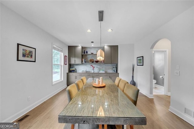 1420 Cortez Ln NE, Atlanta, GA 30319 - dining space with arched walkways, light wood-style floors, and recessed lighting