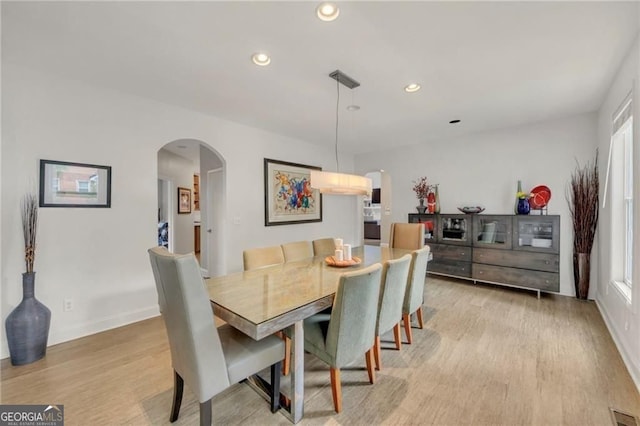 1420 Cortez Ln NE, Atlanta, GA 30319 - dining room featuring arched walkways, light wood-style flooring, recessed lighting, and healthy amount of natural light