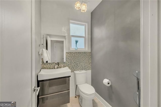 1420 Cortez Ln NE, Atlanta, GA 30319 - bathroom featuring vanity, a chandelier, tile patterned flooring, tile walls, and backsplash