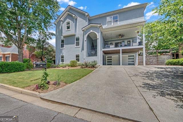 1420 Cortez Ln NE, Atlanta, GA 30319 - view of front of home featuring a garage, driveway, a balcony, a front yard, and stucco siding