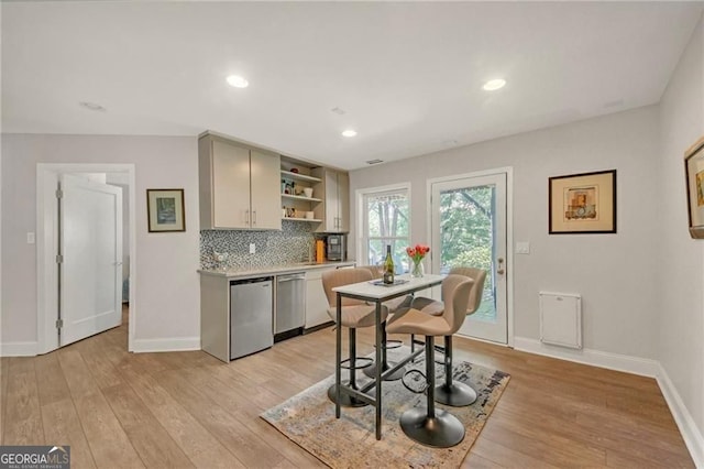 1420 Cortez Ln NE, Atlanta, GA 30319 - kitchen with stainless steel dishwasher, open shelves, decorative backsplash, light wood-style floors, and recessed lighting