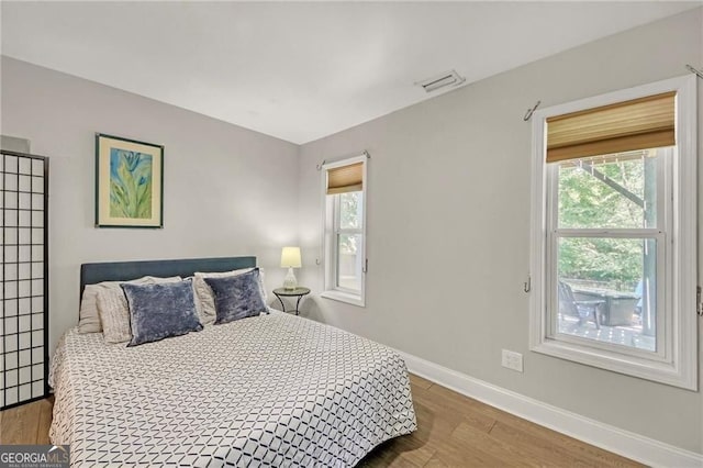 1420 Cortez Ln NE, Atlanta, GA 30319 - bedroom with multiple windows and wood finished floors