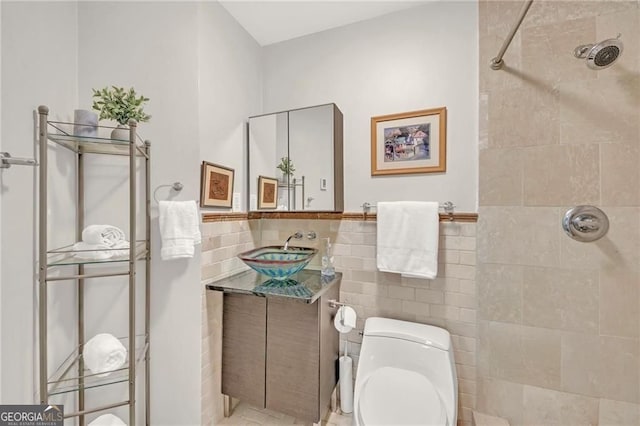1420 Cortez Ln NE, Atlanta, GA 30319 - bathroom with a tile shower, vanity, tile walls, and a wainscoted wall