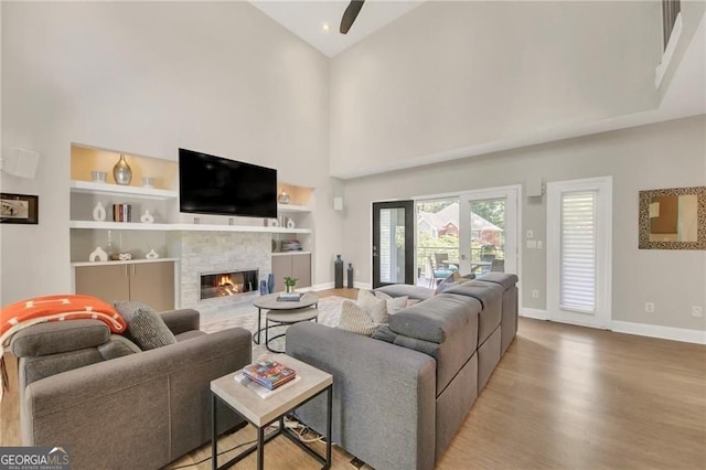 1420 Cortez Ln NE, Atlanta, GA 30319 - living area with high vaulted ceiling, wood finished floors, built in features, a stone fireplace, and ceiling fan