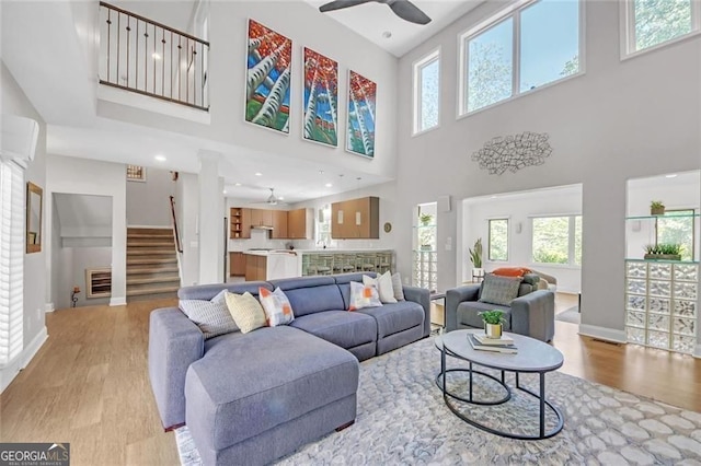 1420 Cortez Ln NE, Atlanta, GA 30319 - living area featuring light wood finished floors, healthy amount of natural light, a towering ceiling, a ceiling fan, and recessed lighting