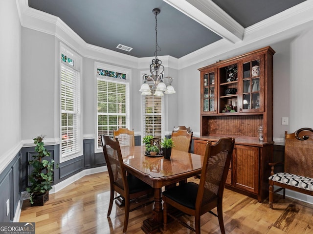 124 Belford Way, Locust Grove, GA 30233 - dining room featuring a chandelier, light wood-style floors, crown molding, and wainscoting