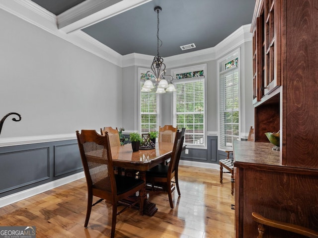 124 Belford Way, Locust Grove, GA 30233 - dining space with a chandelier, light wood-type flooring, crown molding, wainscoting, and a decorative wall