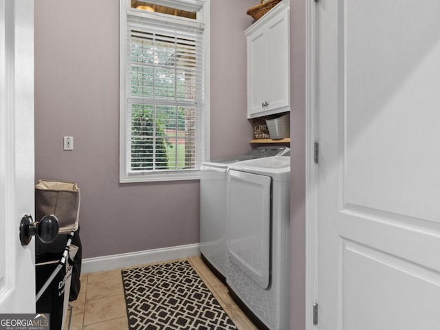 124 Belford Way, Locust Grove, GA 30233 - laundry area featuring washer and clothes dryer, cabinet space, and light tile patterned floors