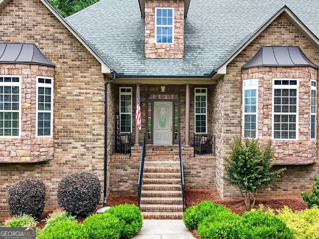 124 Belford Way, Locust Grove, GA 30233 - view of exterior entry with a shingled roof and brick siding