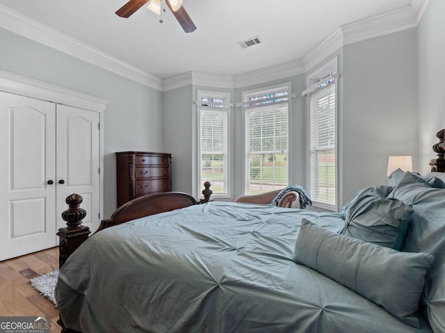 124 Belford Way, Locust Grove, GA 30233 - bedroom with wood finished floors, crown molding, a ceiling fan, and a closet