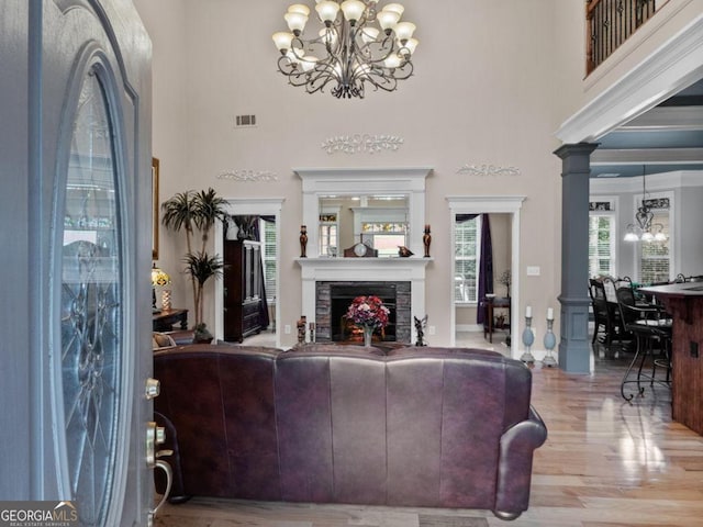 124 Belford Way, Locust Grove, GA 30233 - living area featuring a chandelier, a towering ceiling, wood finished floors, and a fireplace