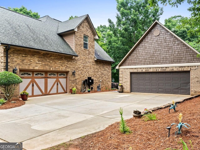 124 Belford Way, Locust Grove, GA 30233 - view of side of home featuring a garage, brick siding, and a shingled roof