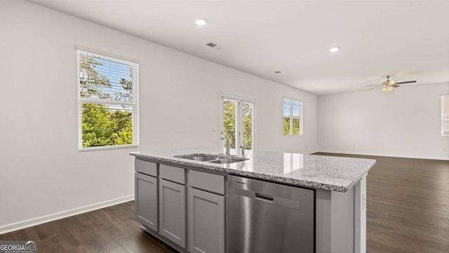 kitchen with dishwasher, dark wood finished floors, an island with sink, gray cabinets, and a ceiling fan