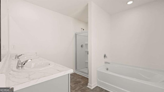 full bathroom with a stall shower, a garden tub, and vanity
