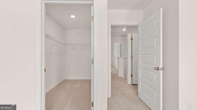 spacious closet with light colored carpet