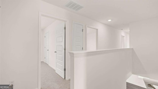 corridor featuring carpet flooring and recessed lighting
