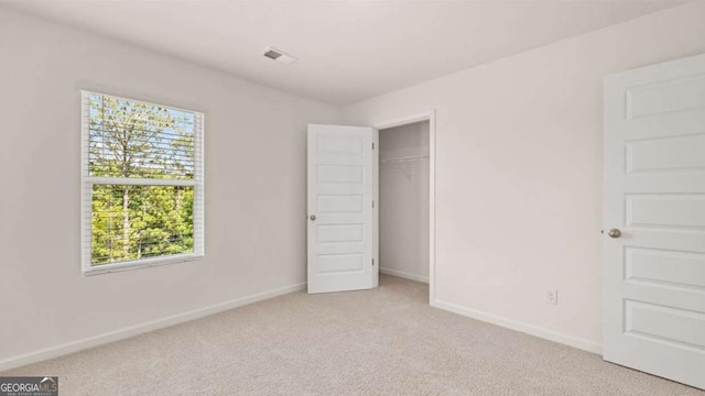 unfurnished bedroom featuring light colored carpet and baseboards