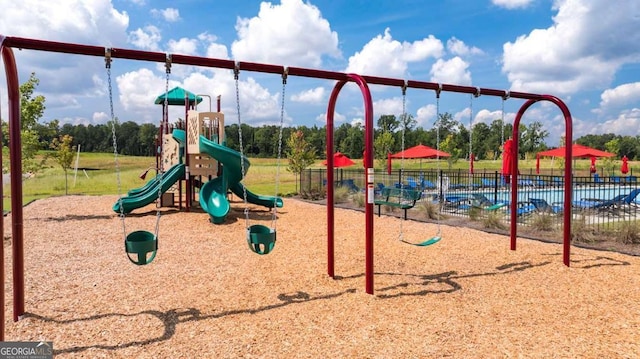 community jungle gym featuring fence